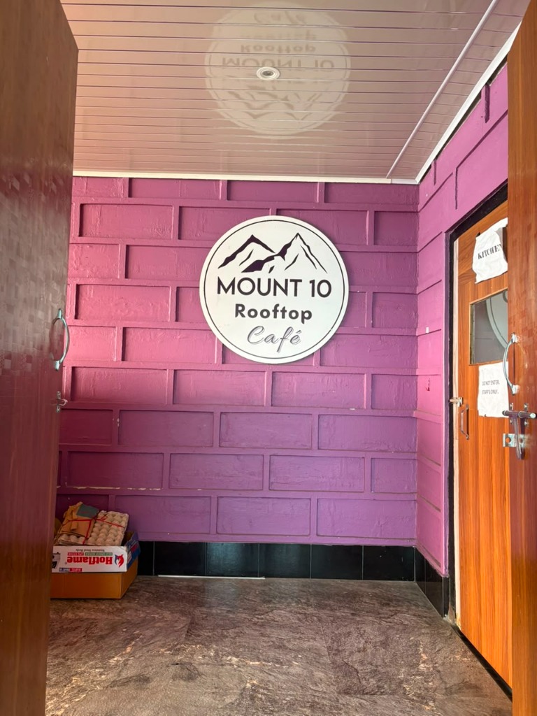 Mount 10 Rooftop Cafe entrance and logo signboard at Bashera Mountain Stay