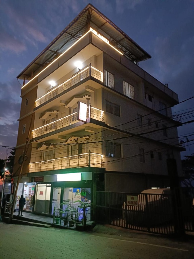 Exterior view of Bashera Mountain Stay illuminated at dusk in Kurseong