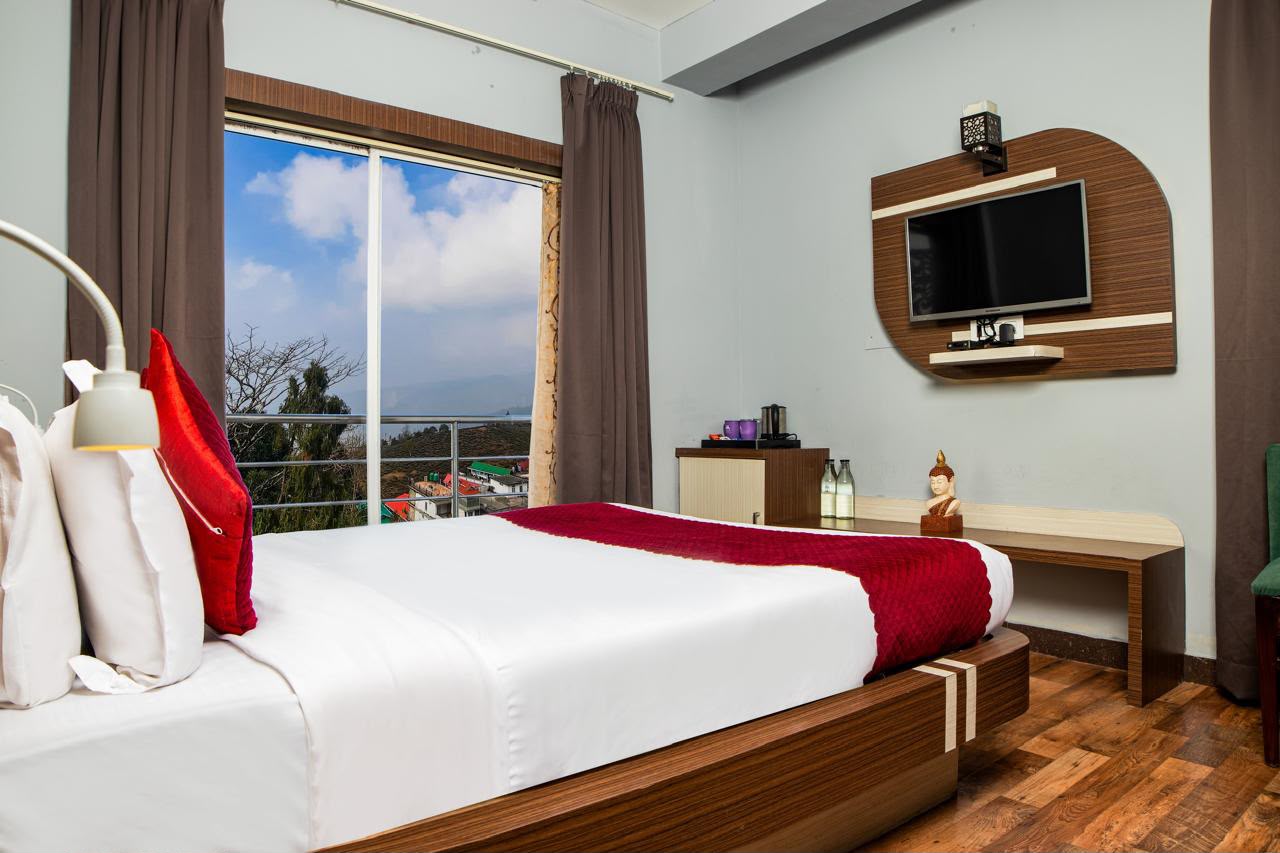 Balcony View Room with scenic mountain view glass doors and television console
