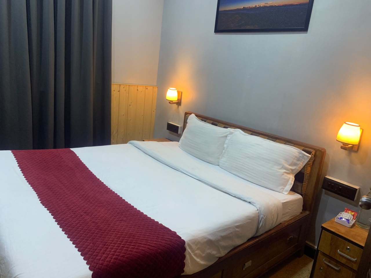Ground Floor Classic Room comfortable bed with warm wall lighting