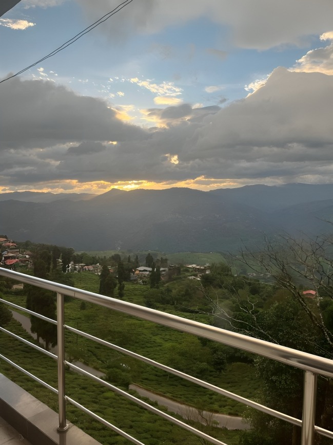 Orange sky and sunset rays breaking through clouds in Kurseong